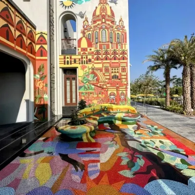 Here, we turned an entire residential facade and courtyard into a canvas. The project features a sprawling, colorful floor mosaic that flows into a massive wall mural depicting the architecture of Rajkot, creating a completely immersive and uninhibited world of color and imagination.