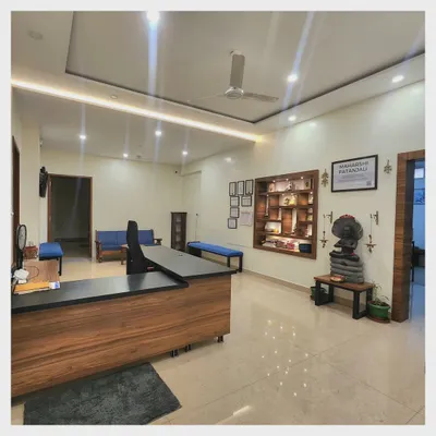 A wide view of our reception area, the first space that welcomes you into our shala. We have designed it to be a calm and inviting entrance, with our display of certifications and a statue of Maharshi Patanjali setting the tone for the practice within.