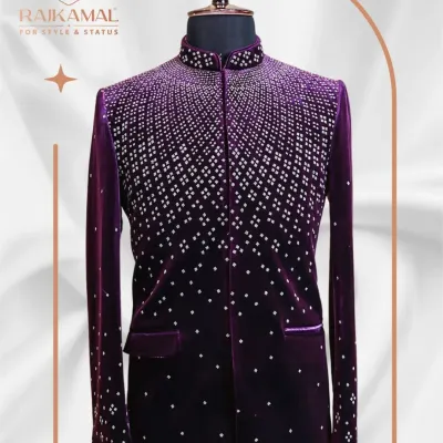 A stunning Jodhpuri suit in rich purple velvet. The jacket features a cascading pattern of silver embellishments, creating a dazzling, starry-night effect that is perfect for a grand reception.