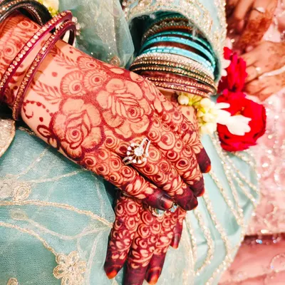 The beautiful, rich stain of an engagement henna, adorned with sparkling rings and bangles. This is the color of celebration.