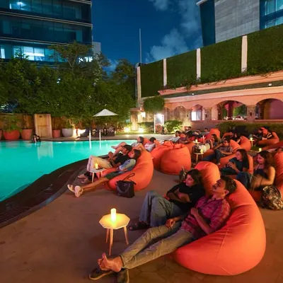 Our Dive-in Cinema setup at the Hilton, Mumbai. You can choose to lounge on bean bags by the poolside or grab a floatie and watch the movie from inside the pool.