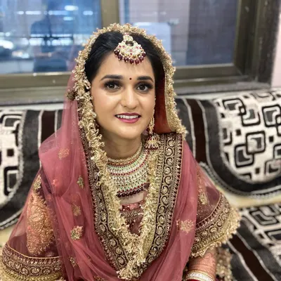 A stunning Punjabi bride on her wedding day. I created a classic bridal look with soft smokey eyes and a rosy lip to complement her beautiful pink and gold lehenga.
