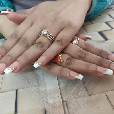 Doing nails is my cardio! A classic French manicure with a touch of gold glitter is a timeless and elegant choice for any bride.
