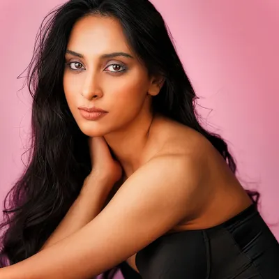 A classic beauty portrait. I used a soft, flattering light setup against a simple pink background to create a clean, elegant look that focuses entirely on the subject's expressive features.