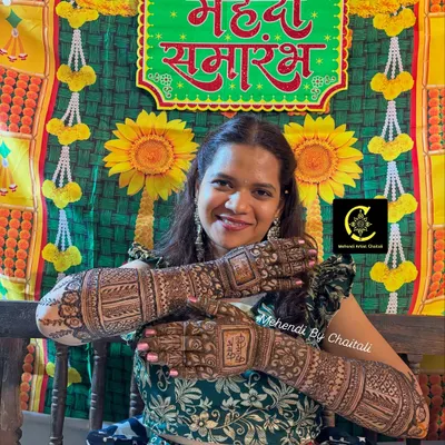 A happy bride posing at her "Mehendi Samarambh" (Mehendi Ceremony). Her smile and her beautiful, dark mehendi are what make my work so fulfilling.