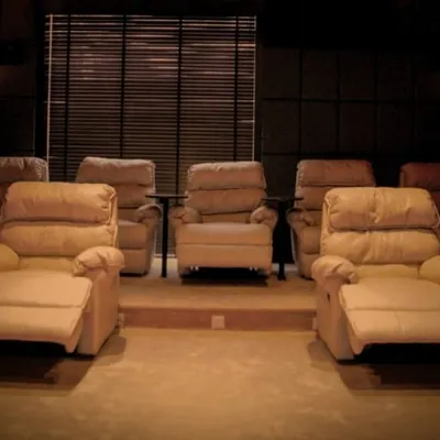Dreaming of a budget-friendly home theater? We can help bring your entertainment oasis to life. This image showcases a beautiful setup with comfortable recliners, proving that a great cinema experience doesn't have to break the bank.