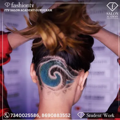 A close-up of a creative hair tattoo executed by a student. This style combines precision clipper work with vibrant color application, showcasing the advanced, artistic skills we teach.