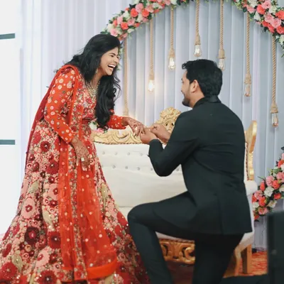 The pure, unscripted joy of a proposal. Nikita's laughter as Dhananjay gets down on one knee is a perfect example of the candid, emotional moments I aim to capture during an engagement ceremony.