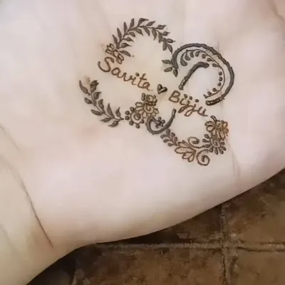 I love adding a personal touch to my designs. Here is an example of a custom heart-shaped design incorporating the couple's names, "Savita" and "Bijju," woven into the pattern.