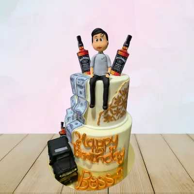 A "Boss" birthday cake for someone who enjoys the finer things. This two-tiered cake features edible money, miniature Jack Daniel's bottles, and a sculpted figurine.