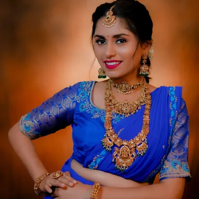 Here's a great example of mix-and-match styling. The same royal blue saree is styled with a heavy, traditional antique set for a grand look.