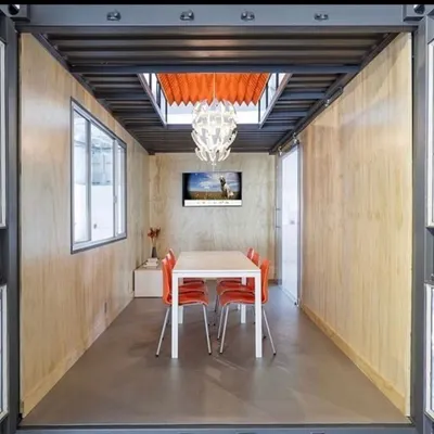 An example of a high-end container meeting room we can create. With its wood-paneled walls, designer lighting, and integrated technology, it offers a private, professional space for collaboration and focus.