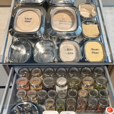 A complete pantry system in two drawers. We organized flours in large, accessible containers and spices in smaller, uniform jars, creating a visual and functional setup for Indian cooking essentials.