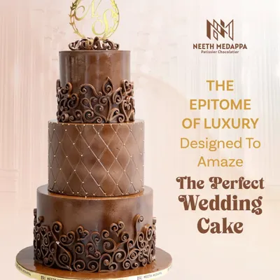 The epitome of luxury, this four-tiered all-chocolate wedding cake is designed to amaze. It features different textures on each tier, from a quilted pattern to intricate heart-shaped scrollwork, all topped with a custom gold monogram.