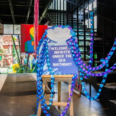 The adventure begins here! A personalized welcome sign with a creative jellyfish design sets the tone for an exciting Under the Sea birthday party from the moment guests arrive.