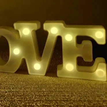A close-up of our warm-white 'LOVE' marquee letters. This type of ambient lighting is a perfect addition to anniversary, engagement, or romantic birthday decorations, adding a soft and celebratory glow.