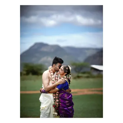 A classic romantic portrait, elevated by the dramatic mountain landscape and cloudy sky. This is about creating that epic, once-in-a-lifetime shot that tells your entire love story.