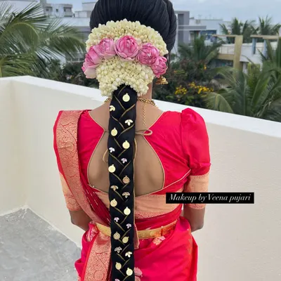 A stunning traditional South Indian bridal braid, adorned with fresh flowers and gold accessories. This hairstyle is a timeless classic for a reason.