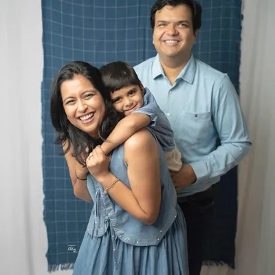 A playful piggyback ride creates the most genuine smiles. This family portrait captures a lighthearted moment of fun and connection between parents and their son during their studio session.