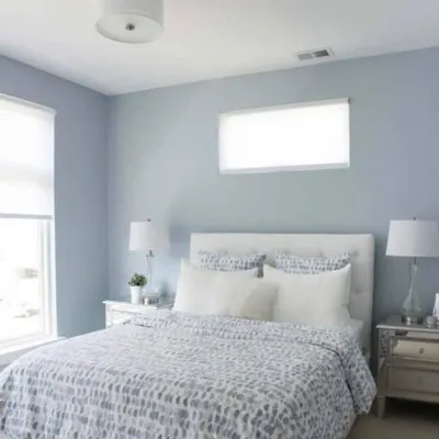 This serene bedroom showcases a soft powder blue on the walls, creating a calm and restful environment. We help you pick shades that promote relaxation.