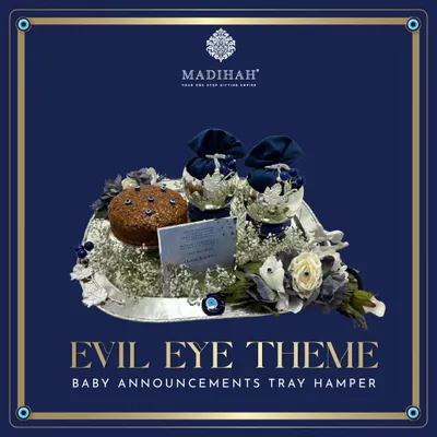 My Evil Eye themed baby announcement tray hamper, designed to offer blessings and protection. This arrangement features a silver tray with navy blue and silver gifts, a personalized card, and the iconic Evil Eye motif.