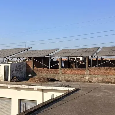 A wide view of the 20 HP solar panel installation in Ram Nagar. The elevated structure ensures the panels are safe and capture maximum sunlight throughout the day, powering heavy motors efficiently.