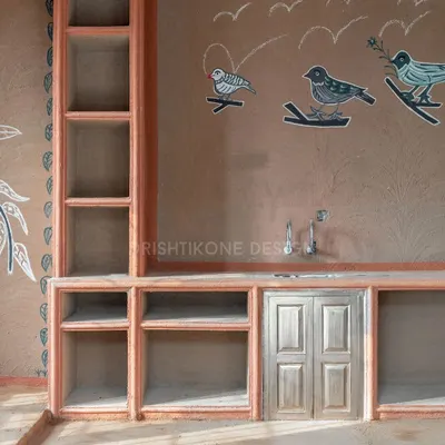 Welcome to "Chulha Rasoi," our unique village-style rooftop kitchen. This space celebrates heritage with authentic clay walls, open shelving, and beautiful chalk murals hand-drawn by local artists.