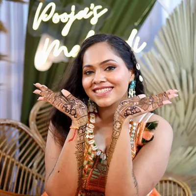 That perfect Mehendi day glow. We kept the makeup fresh and natural to complement her fun, boho-chic outfit and beautiful henna.