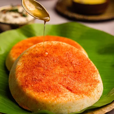 The perfect weekend breakfast for me is podi idli. This shot captures the soft, fluffy texture of the idlis, the vibrant color of the podi, and a glistening drizzle of ghee.