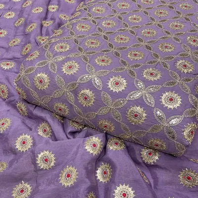 This lavender Chinon fabric is adorned with a beautiful jaal pattern of Gotta Patti work. The delicate silver embroidery and sequin details make it an elegant choice for custom ethnic wear.