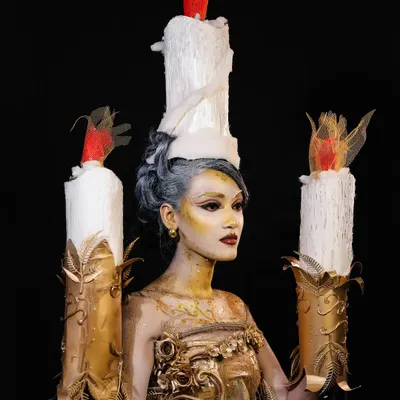 A full-frontal view of the "Lumiere" inspired creation. This look required skills in body painting, custom prop making, and creating a cohesive character from head to toe.