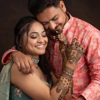 A beautiful moment between the couple, with the bride's intricate mehandi on full display. We love being a part of such special memories.