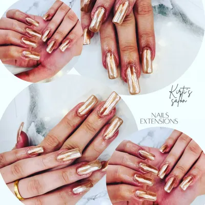 Make a bold statement with these long, square-shaped nail extensions finished with a brilliant gold chrome powder. This technique creates a flawless, mirror-like surface that is incredibly reflective and glamorous.