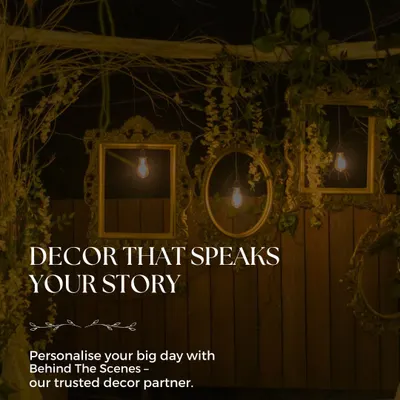 Our trusted decor partner, Behind The Scenes, creates decor that speaks your story. This rustic setup features vintage frames and warm lighting.