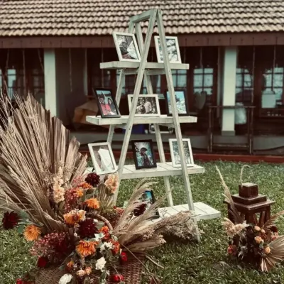 A creative way to display cherished memories. I used a rustic white ladder to create a photo gallery for the couple, surrounded by a beautiful arrangement of dried flowers and pampas grass.