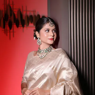 A stunning client wearing one of my signature kundan and meenakari choker sets. The combination of the green enamel, polki stones, and the matching maang tikka perfectly complements her elegant silk saree.