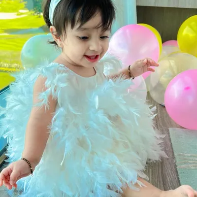The star of her first birthday party. This custom white feather dress was designed for my daughter Aarriya to be light, fluffy, and absolutely magical for her special day.