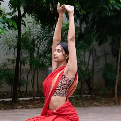 Yoga can be practiced anywhere, in any attire that feels comfortable. Here I am in a simple warm up stretch, showing that the essence of yoga is about finding stillness and breath, not perfection.