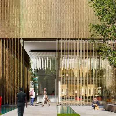 A close-up of the entrance to our mixed-use building in Hyderabad. The facade features a delicate screen of vertical bronze elements, creating a sense of transparency and elegance while defining the transition from the public street to the private interior.