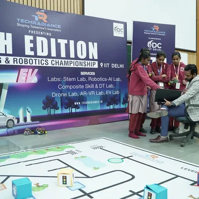 The stage is set for the 9th Edition of our Coding & Robotics Championship at IIT Delhi. Students gather around the arena, making final adjustments and strategizing before the competition begins.