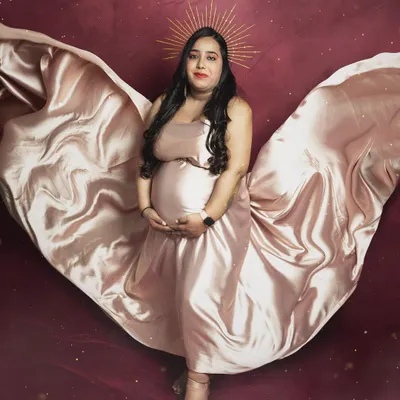 A heavenly portrait of a mother-to-be. The flowing satin wings and the golden halo edit create a truly angelic and magical image.