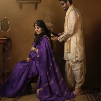 A quiet moment of connection during a traditional maternity shoot. Here, the husband performs the 'sambrani' ritual, a beautiful act of care that I capture to make your photos deeply personal and culturally rich.