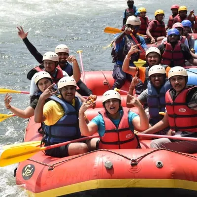 A group of excited trekkers enjoying white water rafting on the Kali river, which is part of our Ulavi Caves adventure package.