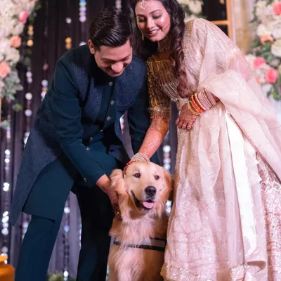 A heartwarming moment where the couple showers their beloved golden retriever with affection during their Sangeet. Including pets in the celebration adds a layer of personal, unconditional love to the day.