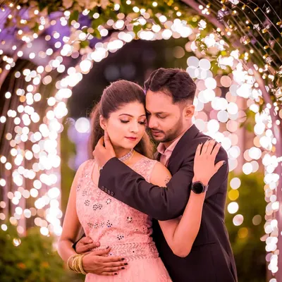 An intimate embrace under a glowing archway. I use fairy lights to create a soft, romantic ambiance that is perfect for close-up, emotional couple portraits.
