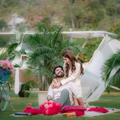 A romantic picnic scene set in our expansive green lawn. This setup features our unique yellow airplane prop in the background, adding a touch of whimsy to this pre-wedding shoot.