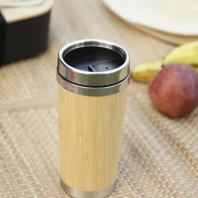 Our bamboo travel mug, shown here in a picnic setting, is perfect for enjoying your favorite beverage anywhere. With a secure lid and stainless steel interior, it's a durable and sustainable choice for your daily coffee or tea.