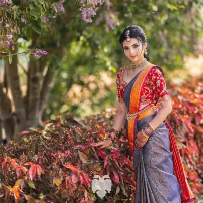 Jahnavi looks absolutely radiant in this custom red velvet blouse for her pre wedding ceremony. The flowing gold zardosi and sequin patterns were designed to create a sense of rhythm and movement, making her look unforgettable.