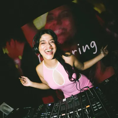 In the zone behind the DJ decks. I love mixing music and seeing the crowd react to the beats.