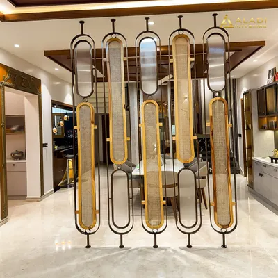 An artistic and functional partition made of metal and woven cane panels. This piece acts as a beautiful screen between the dining and living areas while allowing light to pass through.